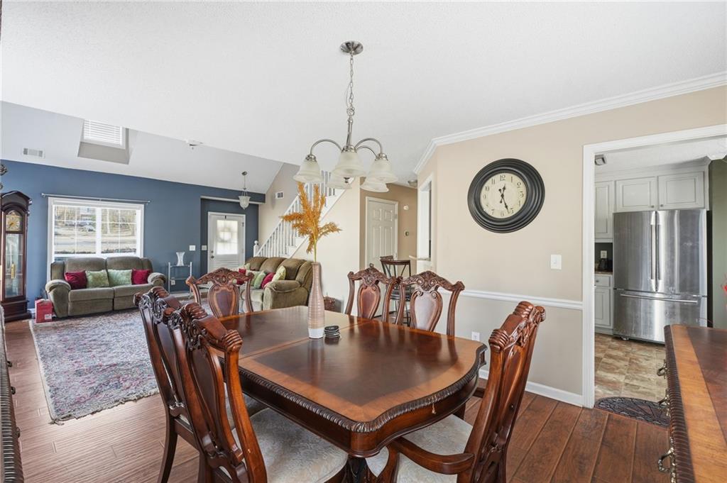 355 Radcliffe Trace Covington, GA 30016 - Photo 6 of 28 a view of a dining room with furniture window and wooden floor