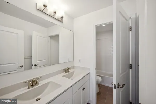 a bathroom with a sink double vanity and a mirror