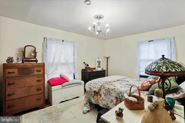 a bedroom with a bed and chandelier