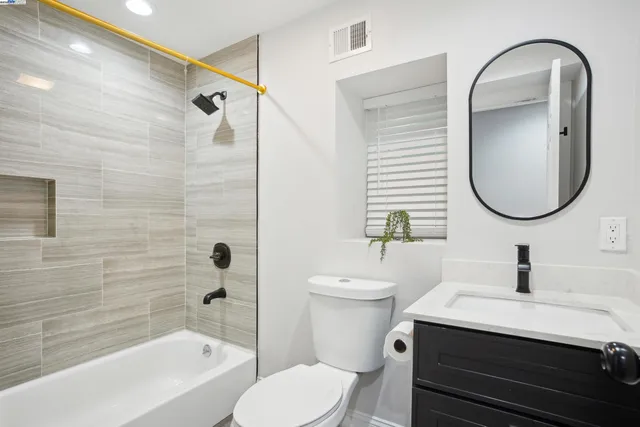 a bathroom with a sink a toilet and a mirror