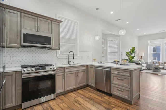 a kitchen with a sink stove and cabinets