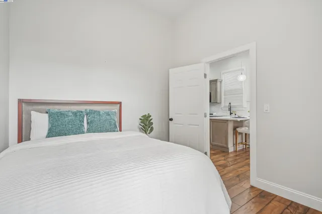 a bedroom with a large bed and a view of bathroom