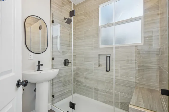 a bathroom with a sink a mirror and shower