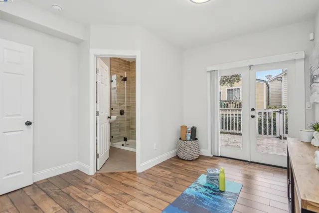 a view of wooden floor and windows in a room