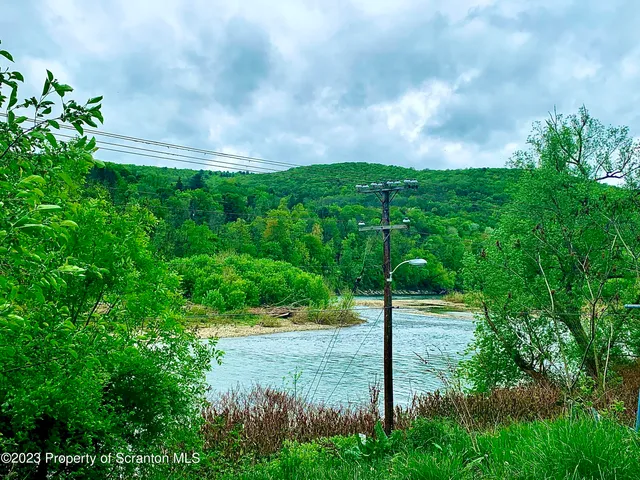 a view of a street with a yard
