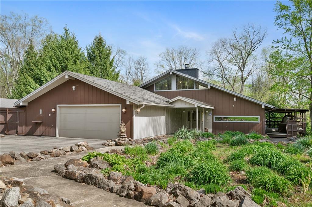 One-owner built, one-owner lived in. A contemporary ranch set among mature trees with attached two-car garage.