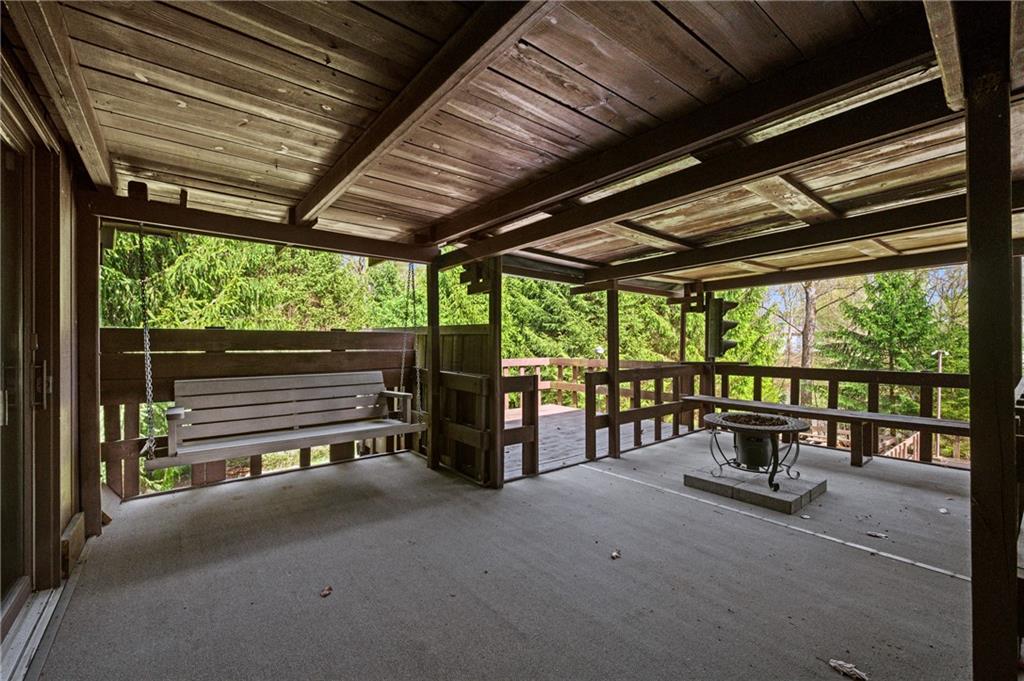 3132 Lake Road New Castle, PA 16102 - Photo 36 of 47 A separate covered seating area with porch swing seating overlooking the gardens and tree canopy.