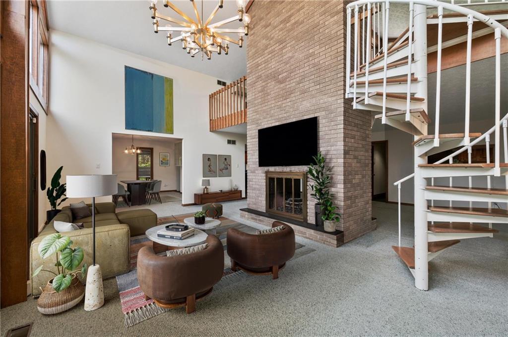 3132 Lake Road New Castle, PA 16102 - Photo 4 of 47 Two-sided gas fireplace anchors the living and family rooms without closing it off. (Virtually staged)