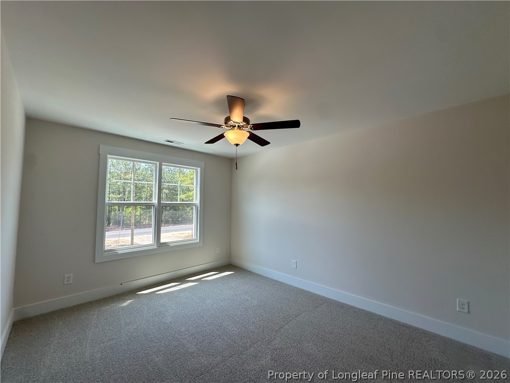 2908 Calloway Road Raeford, NC 28376 - Photo 22 of 25 an empty room with a window and a fan