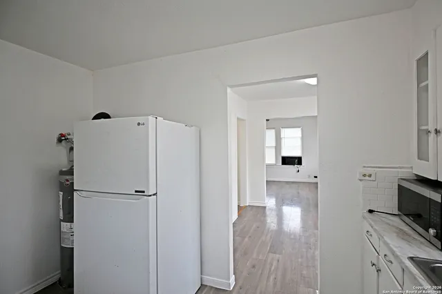 a view of kitchen with furniture and wooden floor
