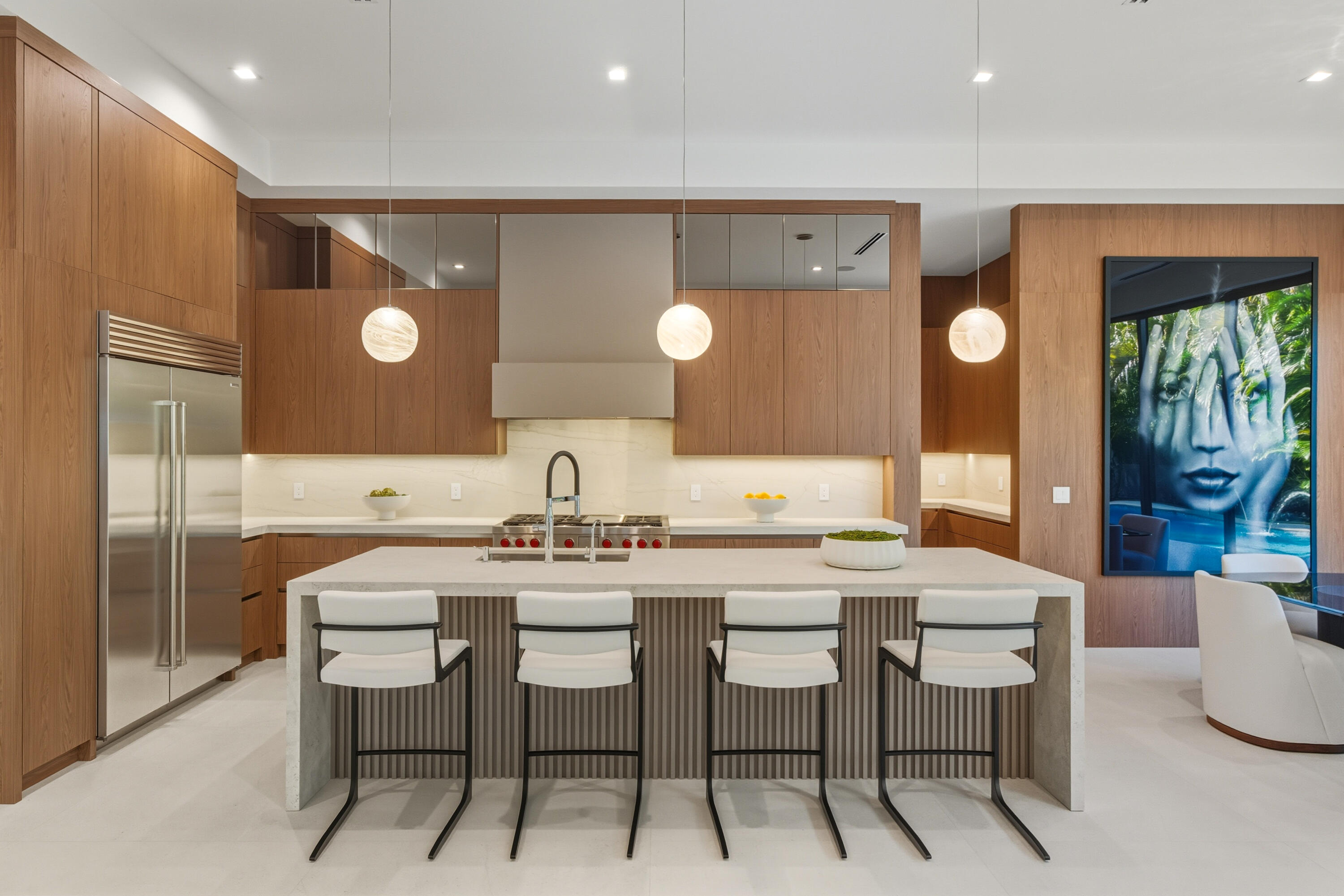 450 Northeast Spanish Court Boca Raton, FL 33432 - Photo 12 of 32 a kitchen with a table and chairs in it