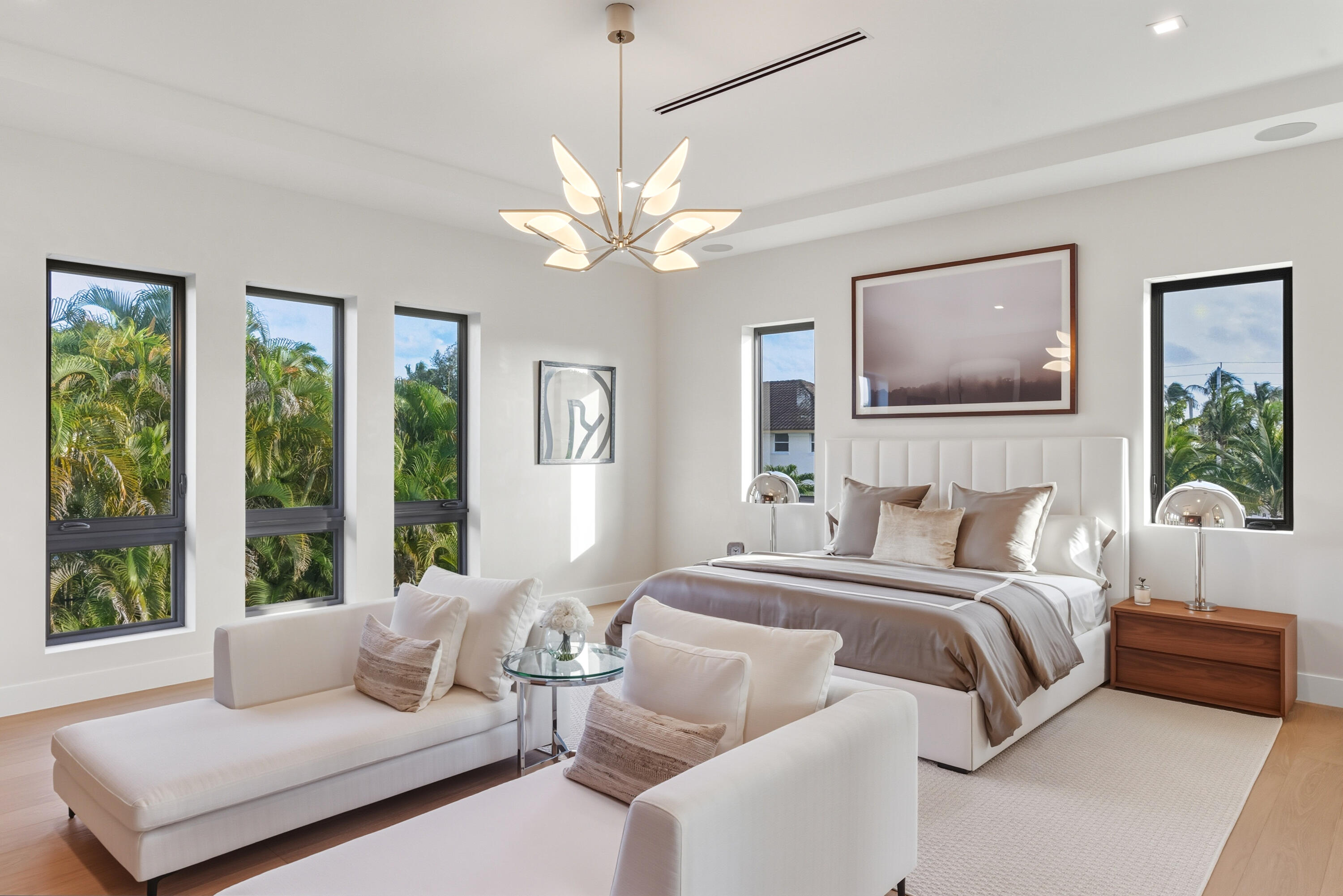 450 Northeast Spanish Court Boca Raton, FL 33432 - Photo 17 of 32 a bedroom with a large bed couch and windows