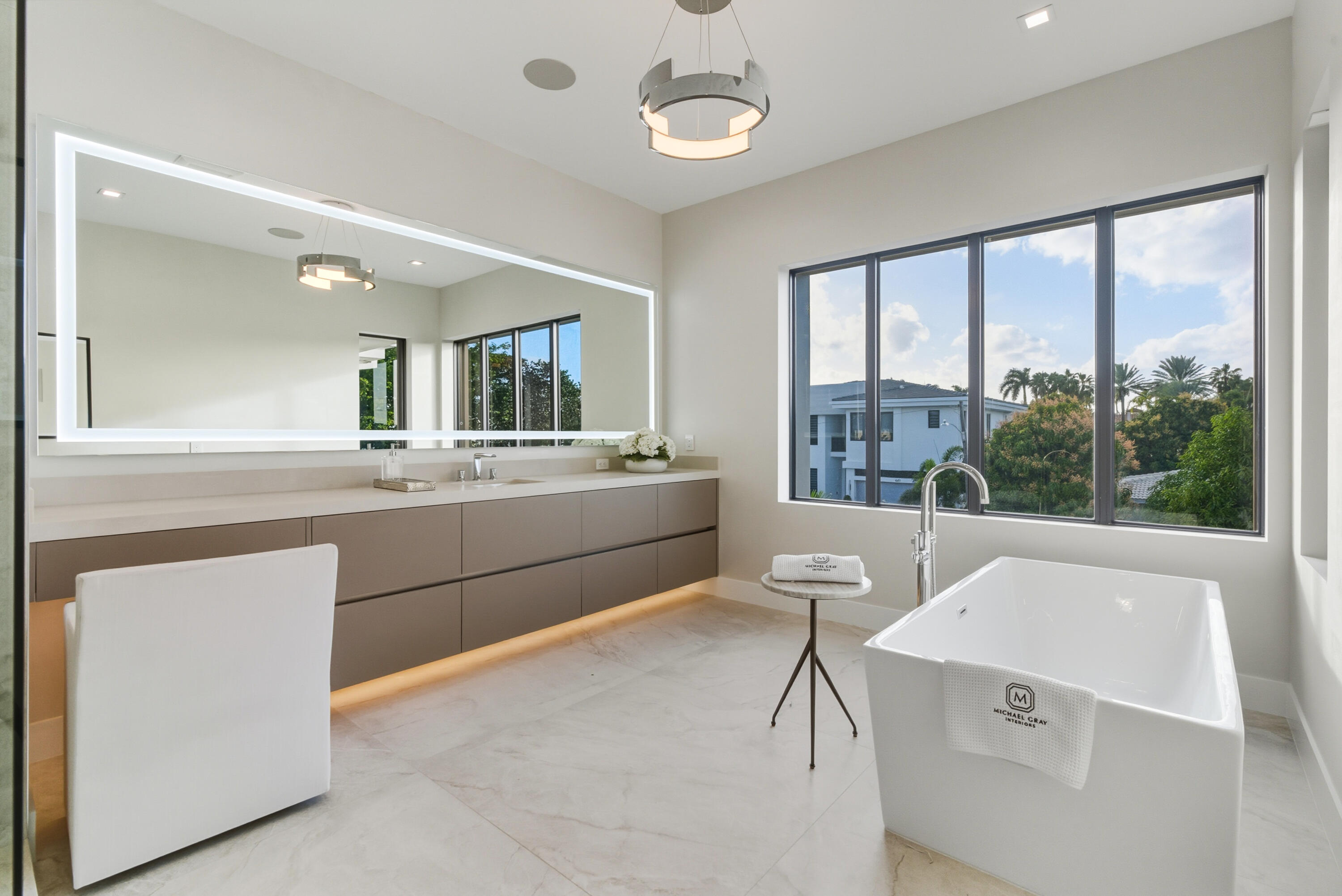 450 Northeast Spanish Court Boca Raton, FL 33432 - Photo 19 of 32 a room with a sink a large mirror and a large window