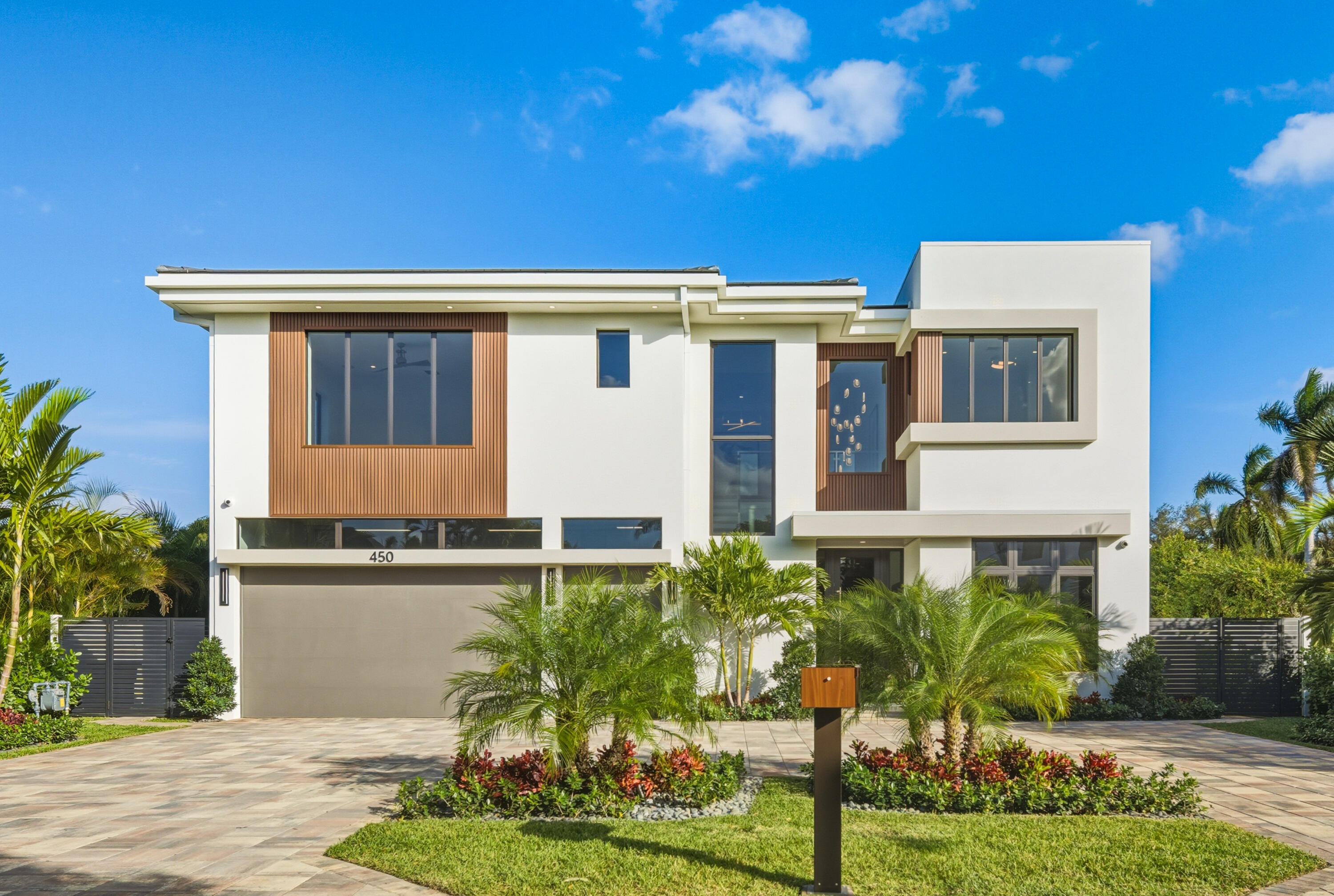 450 Northeast Spanish Court Boca Raton, FL 33432 - Photo 2 of 32 a front view of a house with garden