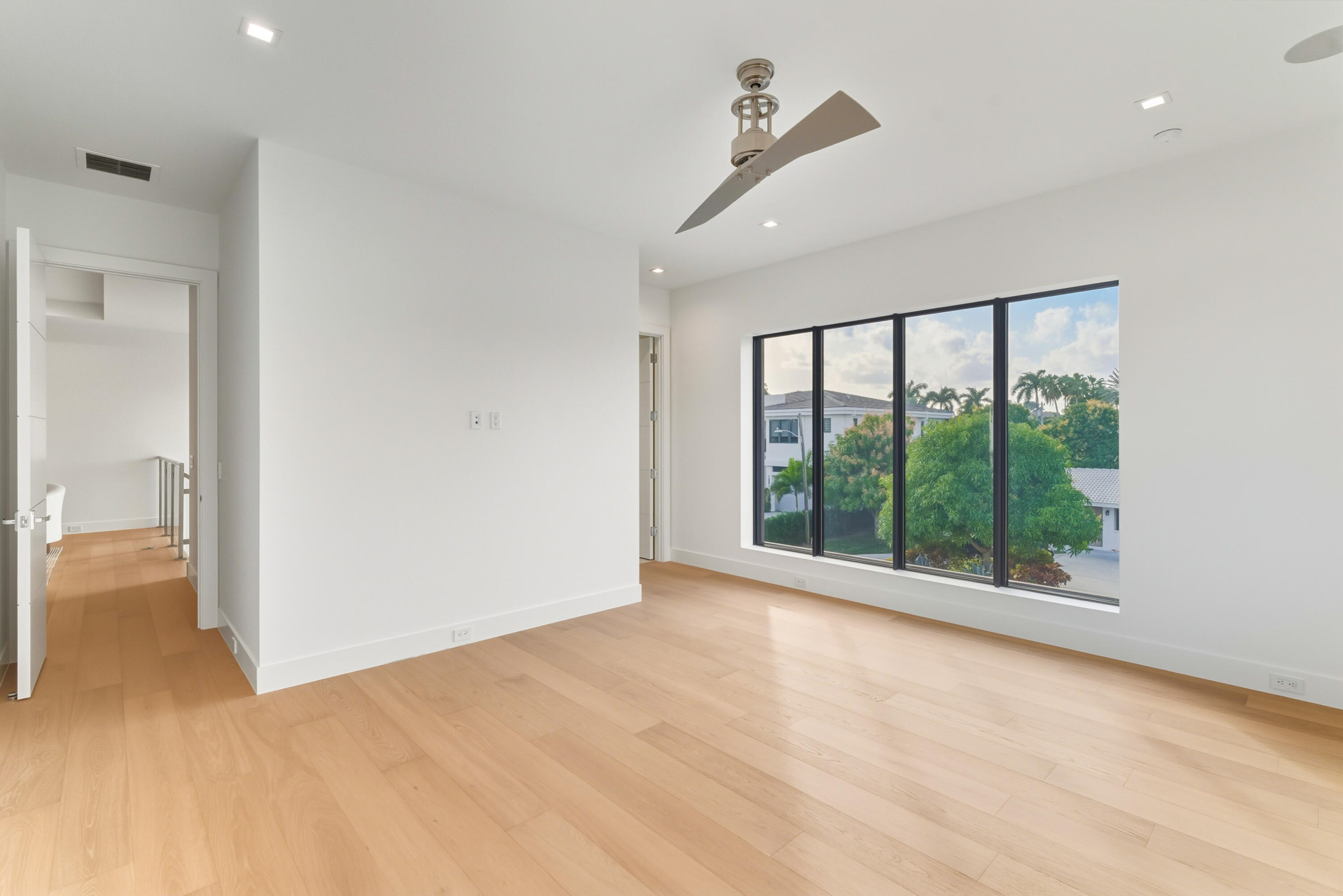 450 Northeast Spanish Court Boca Raton, FL 33432 - Photo 22 of 32 a view of an empty room with a sliding door
