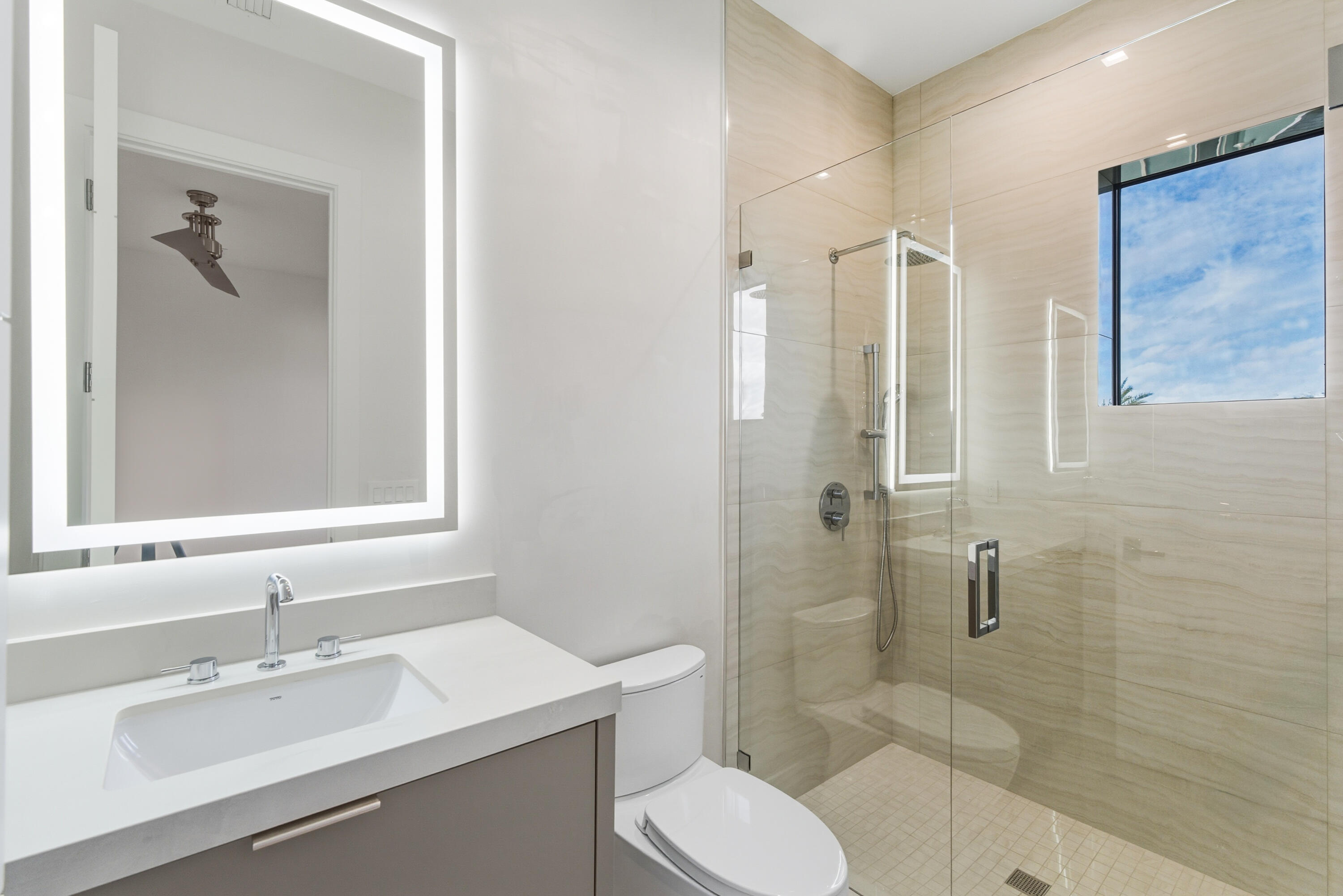 450 Northeast Spanish Court Boca Raton, FL 33432 - Photo 23 of 32 a bathroom with a sink toilet and shower