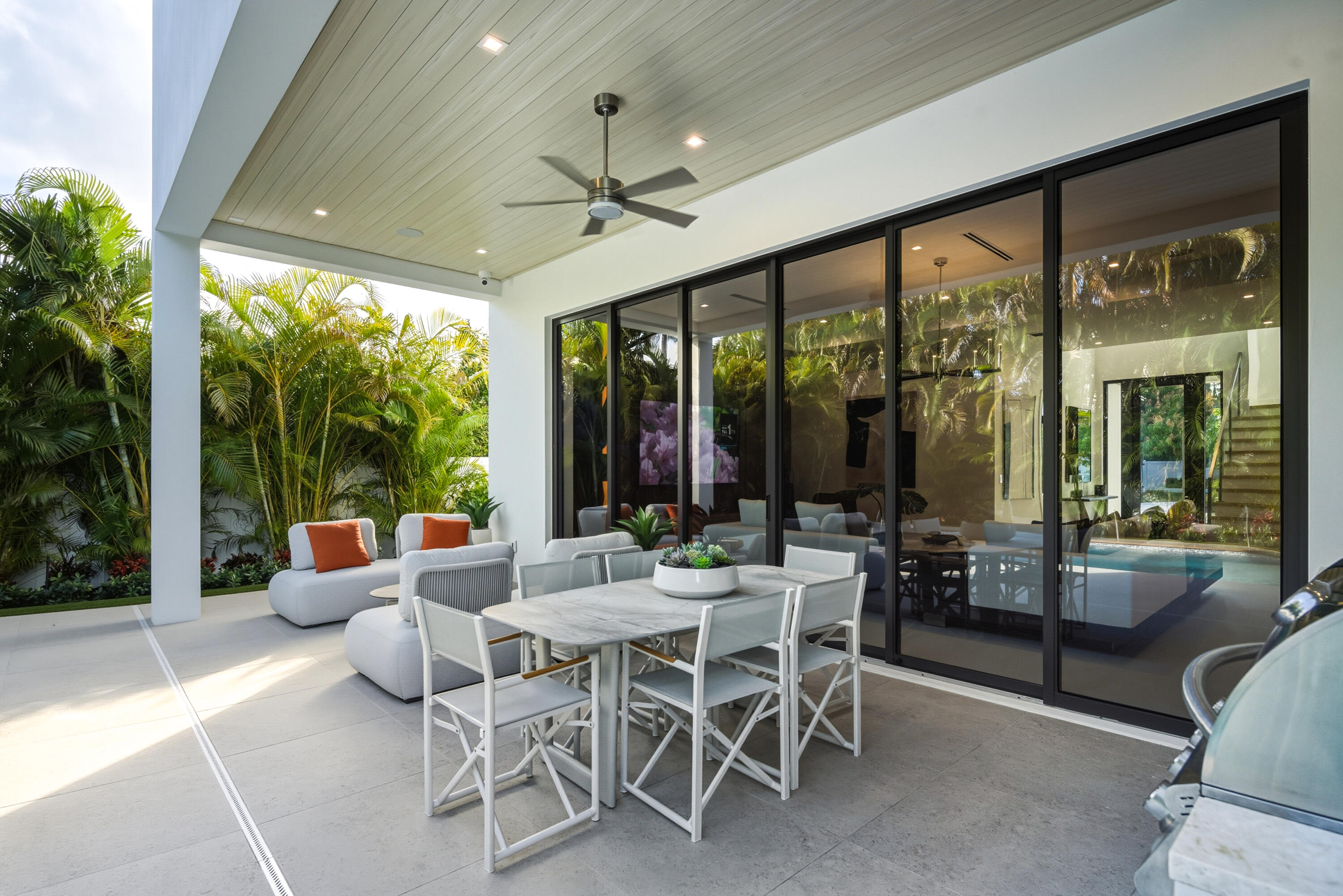 450 Northeast Spanish Court Boca Raton, FL 33432 - Photo 24 of 32 a view of a dining room with furniture large windows and outdoor view