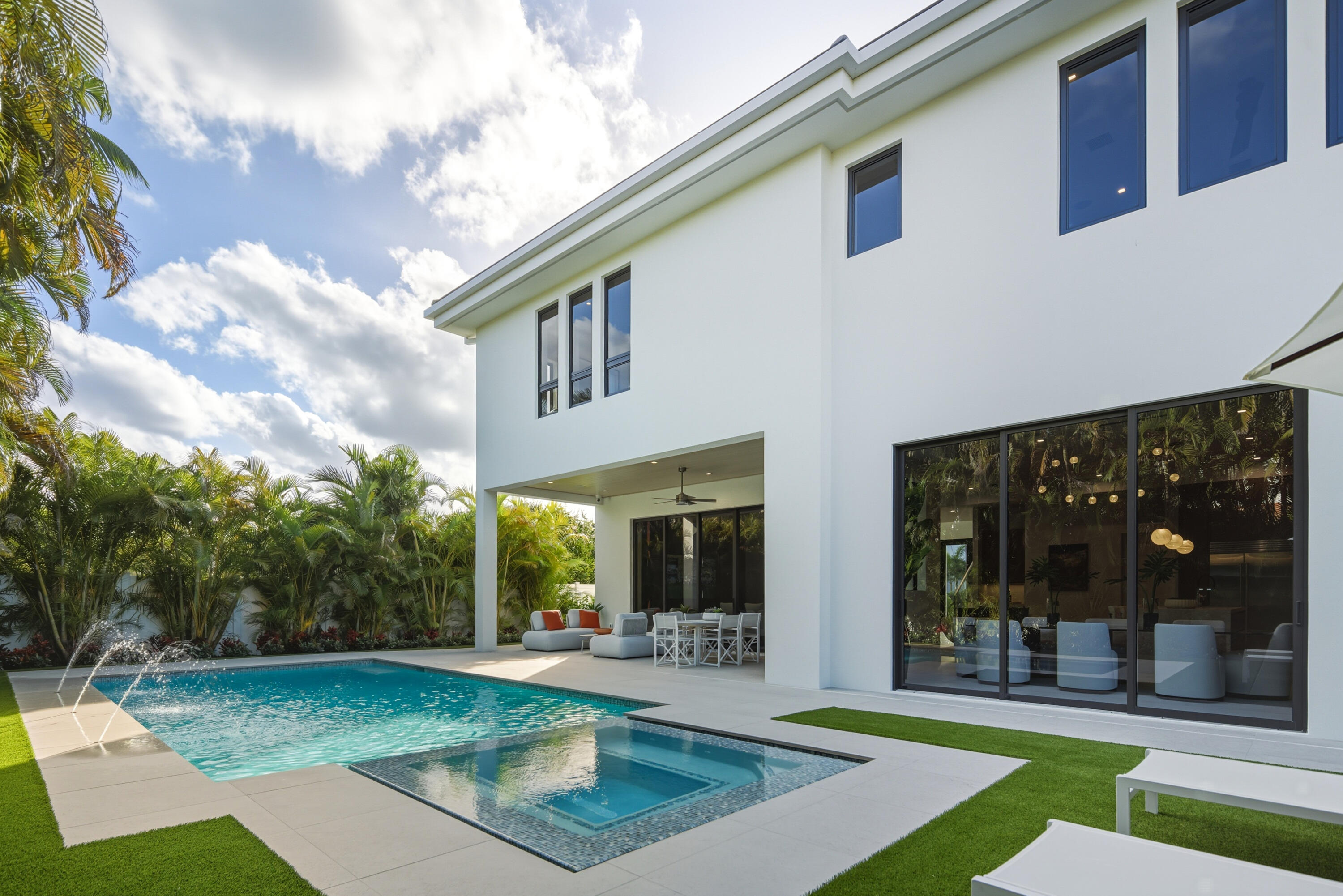 450 Northeast Spanish Court Boca Raton, FL 33432 - Photo 30 of 32 a view of a house with backyard porch and sitting area