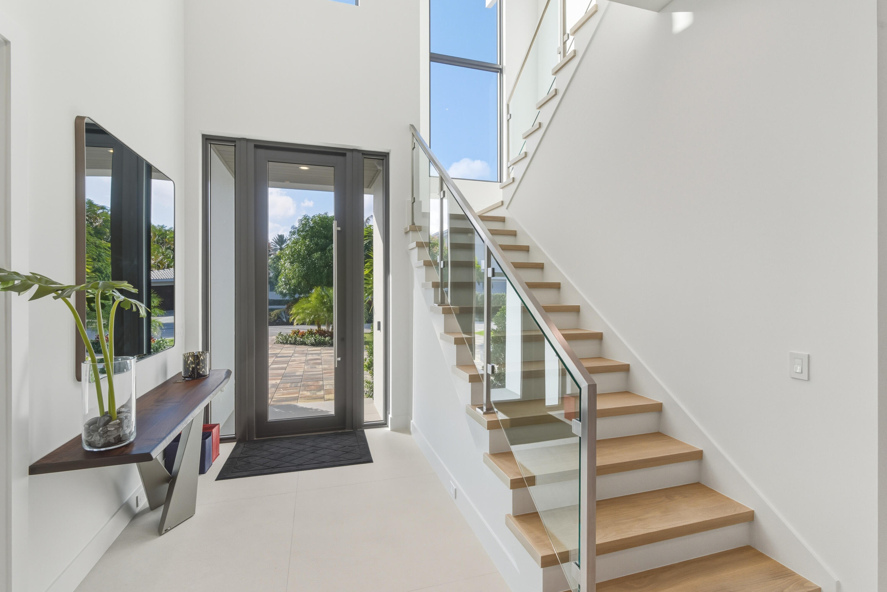 450 Northeast Spanish Court Boca Raton, FL 33432 - Photo 4 of 32 a view of entryway with wooden floor and a front door