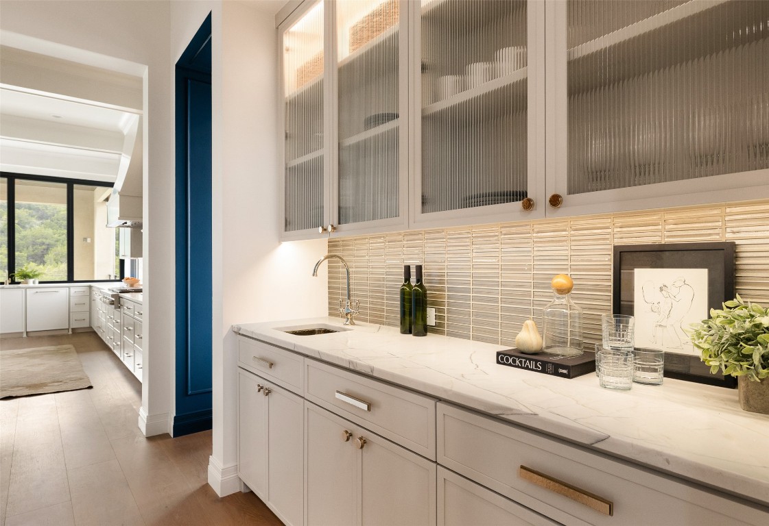 9117 Brookhurst Cove Austin, TX 78733 - Photo 11 of 40 a bathroom with a granite countertop sink and a mirror