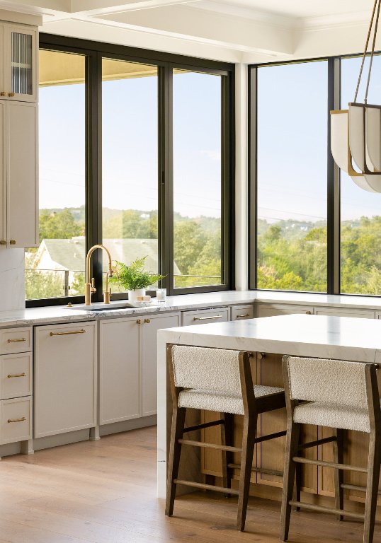 9117 Brookhurst Cove Austin, TX 78733 - Photo 12 of 40 a white stove top oven sitting next to a window