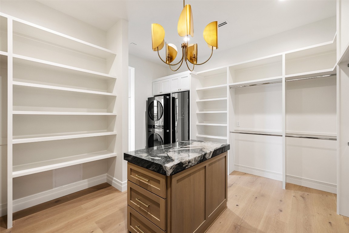 9117 Brookhurst Cove Austin, TX 78733 - Photo 23 of 40 a kitchen with a refrigerator and cabinets