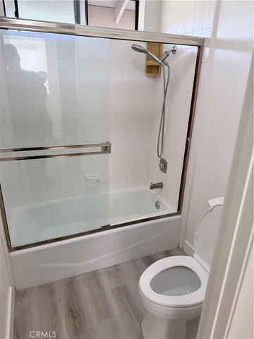 a bathroom with a sink a toilet and a shower