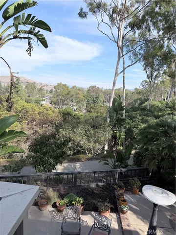 a view of a backyard with plants and outdoor seating