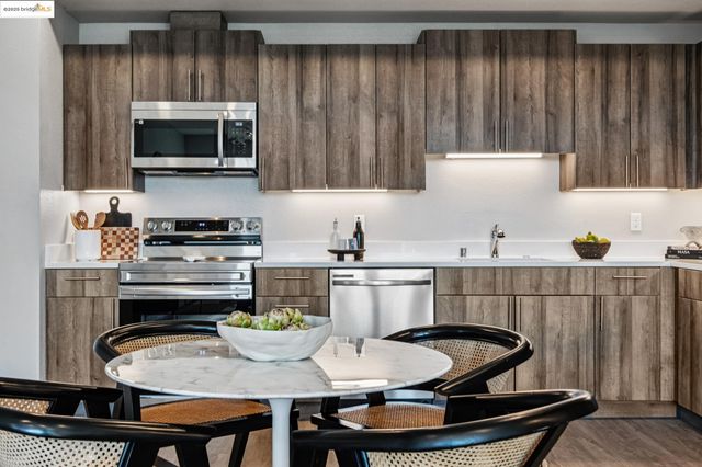 a kitchen with a dining table and chairs