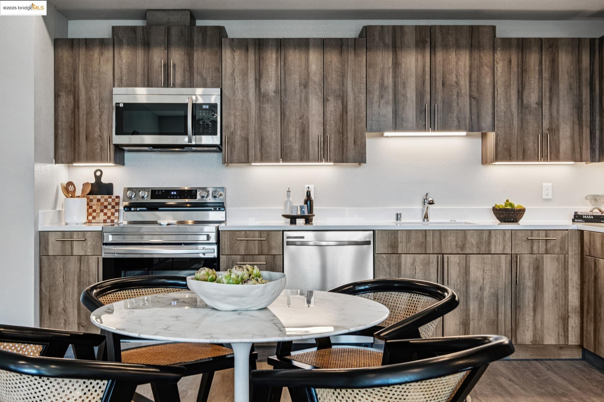 2400 Adeline Street, Unit 404 Oakland, CA 94607 - Photo 12 of 38 a kitchen with a dining table and chairs