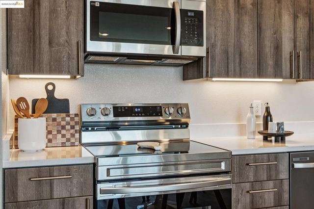 a kitchen with stainless steel appliances a stove and a microwave