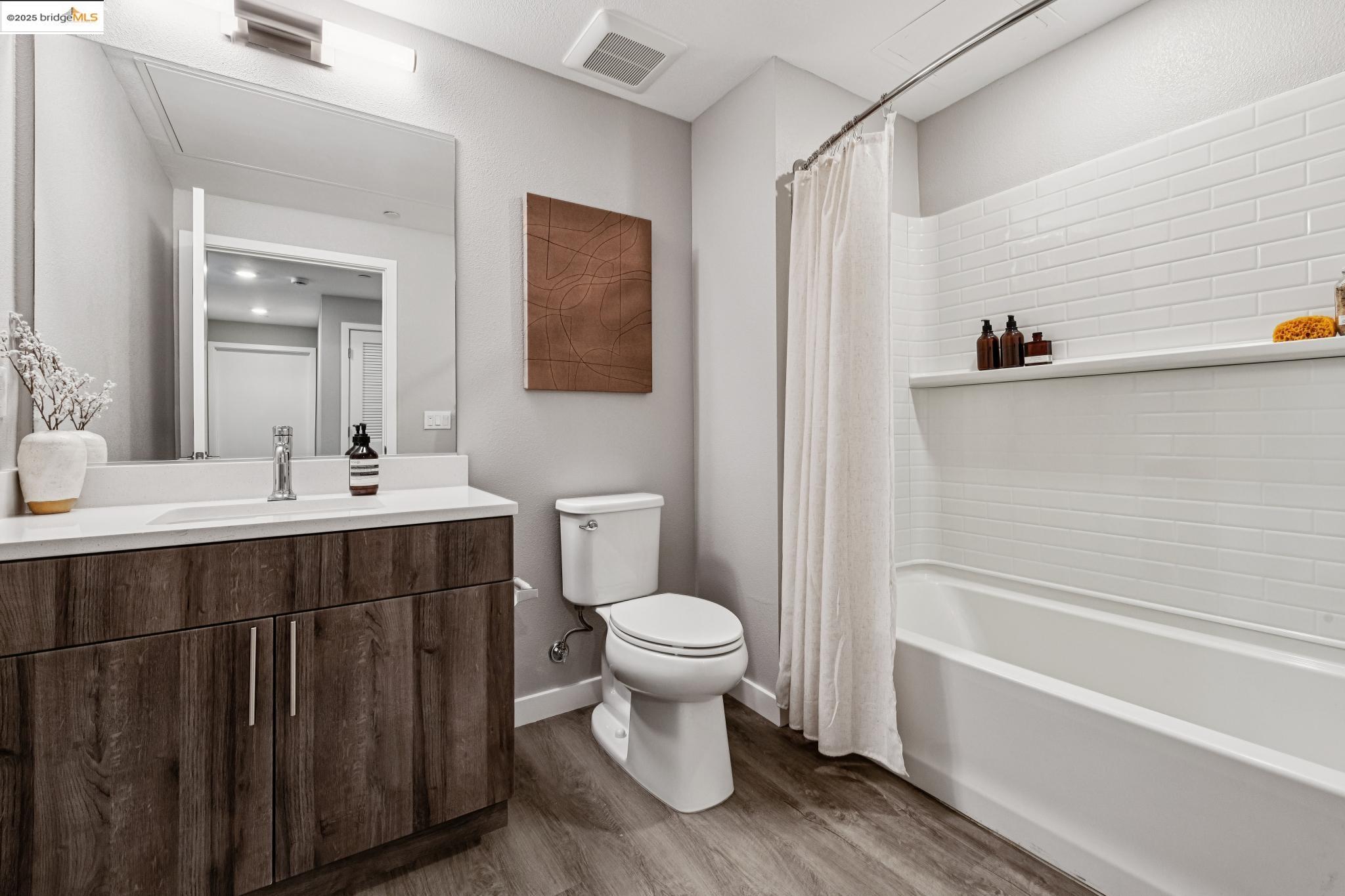 2400 Adeline Street, Unit 404 Oakland, CA 94607 - Photo 20 of 38 a bathroom with a sink a toilet and a bathtub
