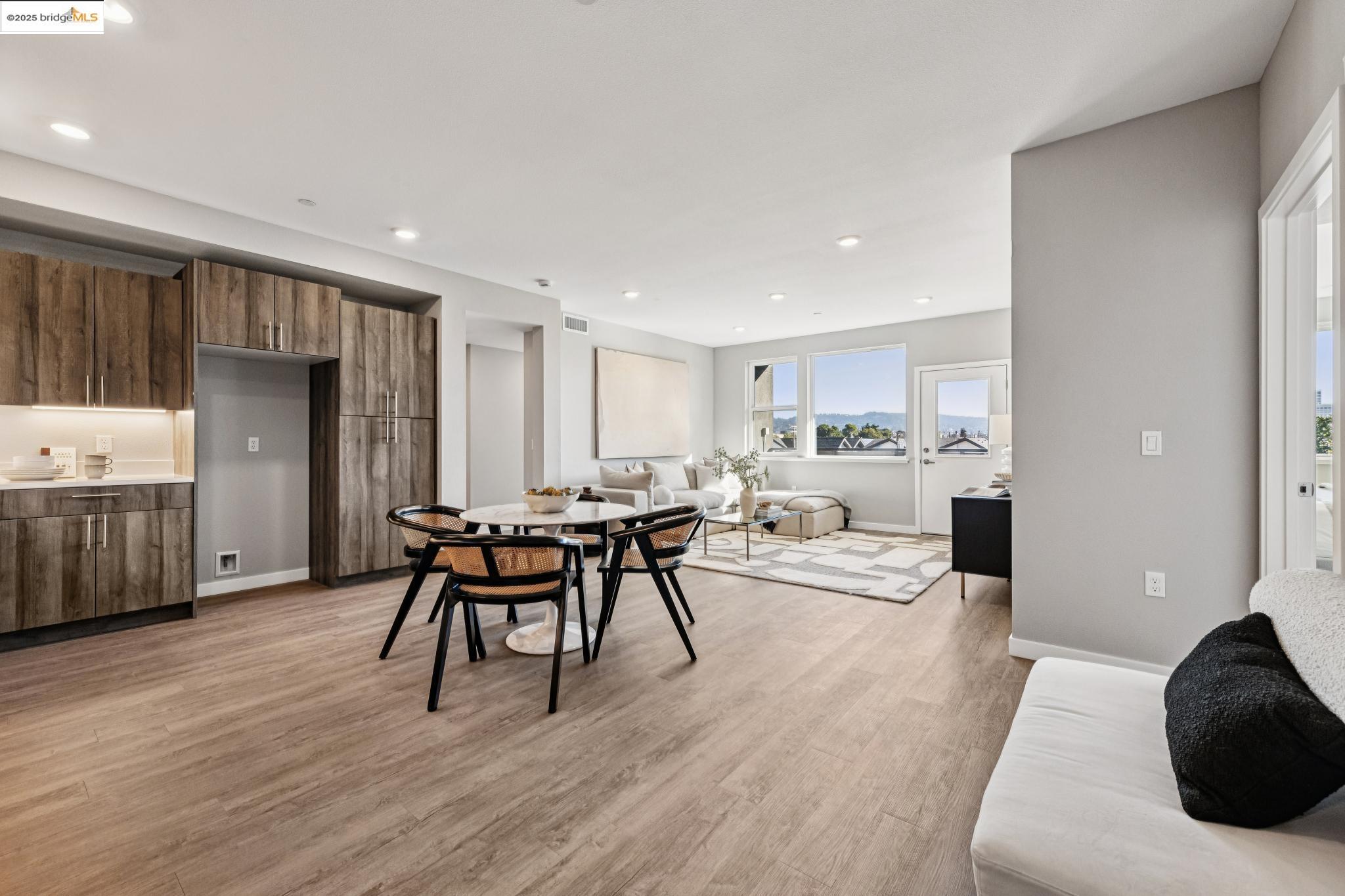 2400 Adeline Street, Unit 404 Oakland, CA 94607 - Photo 3 of 38 a living room with furniture and a wooden floor