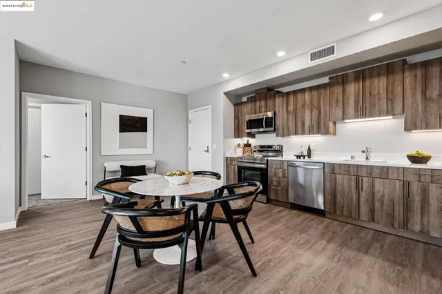 a kitchen with a table chairs a sink and cabinets