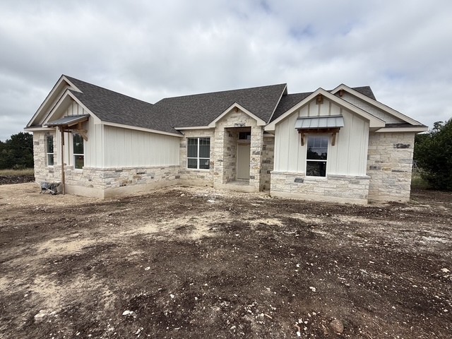 127 Riparian Elms Road Bertram, TX 78605 - Photo 1 of 22 A newly constructed residence combines board and batten siding with stone accents for captivating curb appeal.