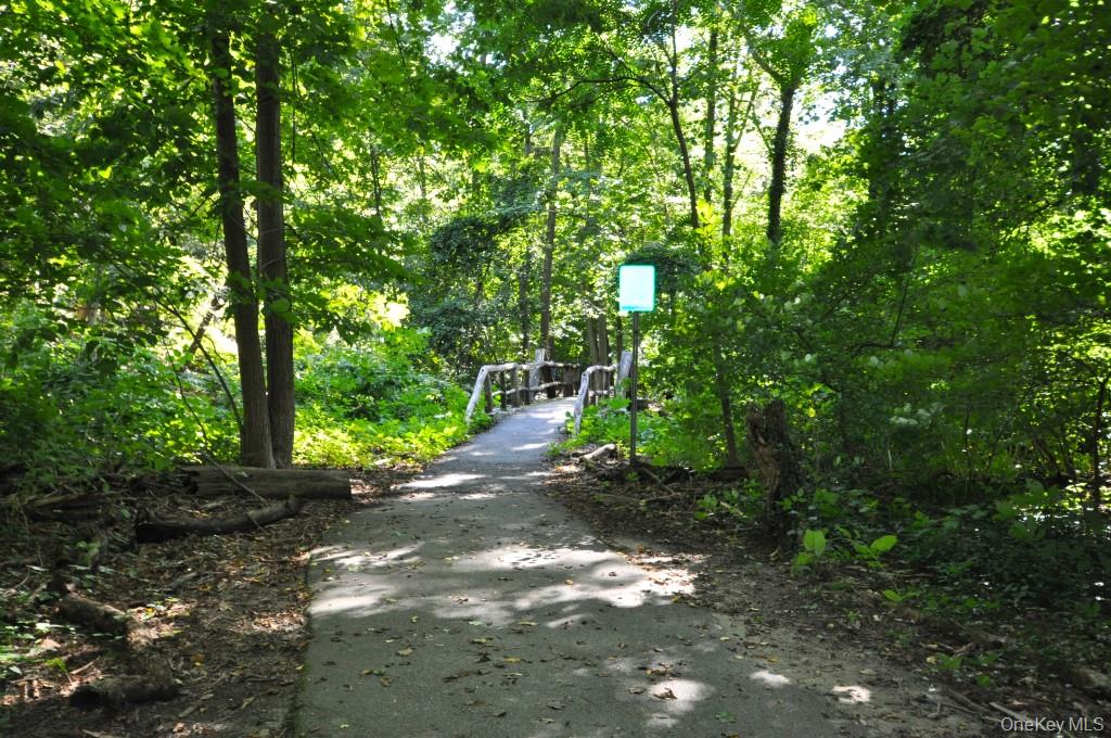 143 Garth Road, Unit 5J Scarsdale, NY 10583 - Photo 42 of 47 a pathway of a yard