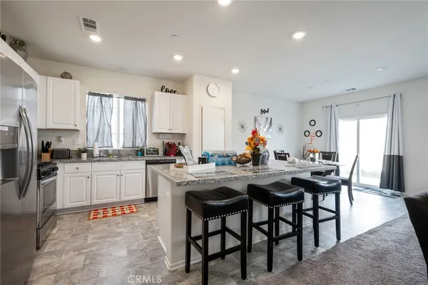 a kitchen with a table chairs stove and cabinets