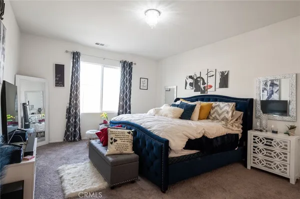 a bedroom with a bed couch and window