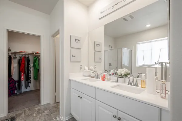 a bathroom with a double vanity sink and a mirror