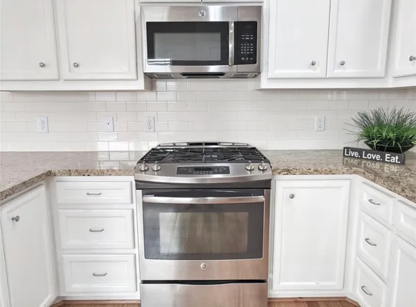 a stove top oven sitting inside of a kitchen