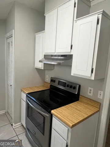 a stove top oven sitting inside of a kitchen