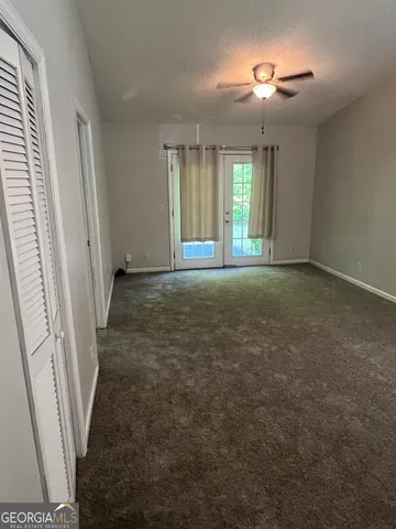 an empty room with windows and entrance