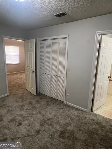 an empty room with closet area