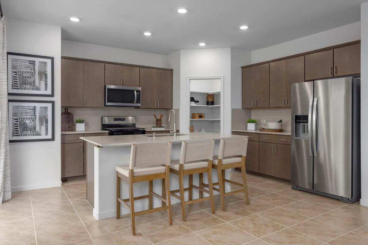 1701 Apiary Way Hughson, CA 95326 - Photo 4 of 13 a kitchen with kitchen island white cabinets and stainless steel appliances