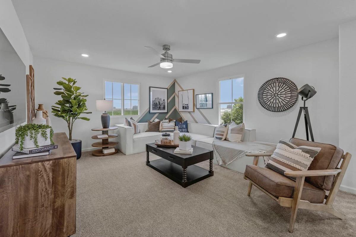 1701 Apiary Way Hughson, CA 95326 - Photo 7 of 13 a living room with furniture a rug and a chandelier