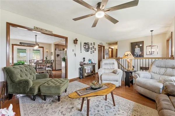 a living room with furniture and a chandelier
