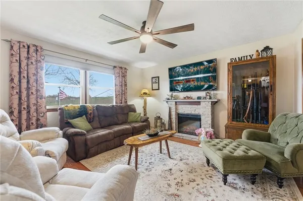 a living room with furniture a fireplace and a flat screen tv