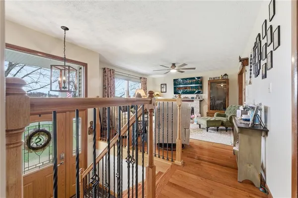 a view of a hallway with wooden floor and windows