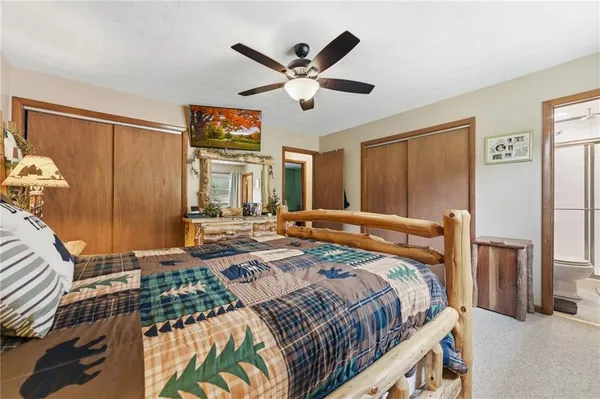a bed room with a bed and two windows
