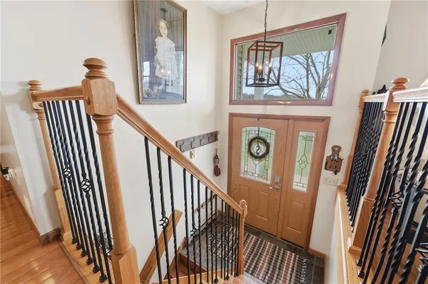 a view of a hallway with wooden floor and staircase